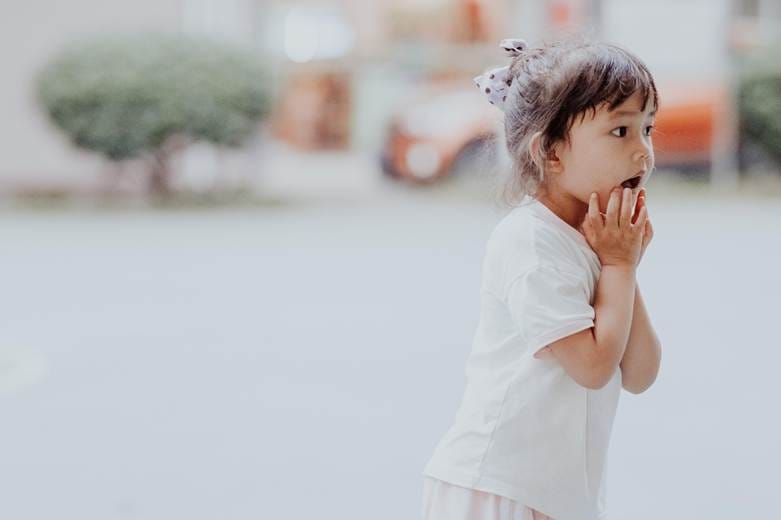 A child with her hands in her mouth

AI-generated content may be incorrect.